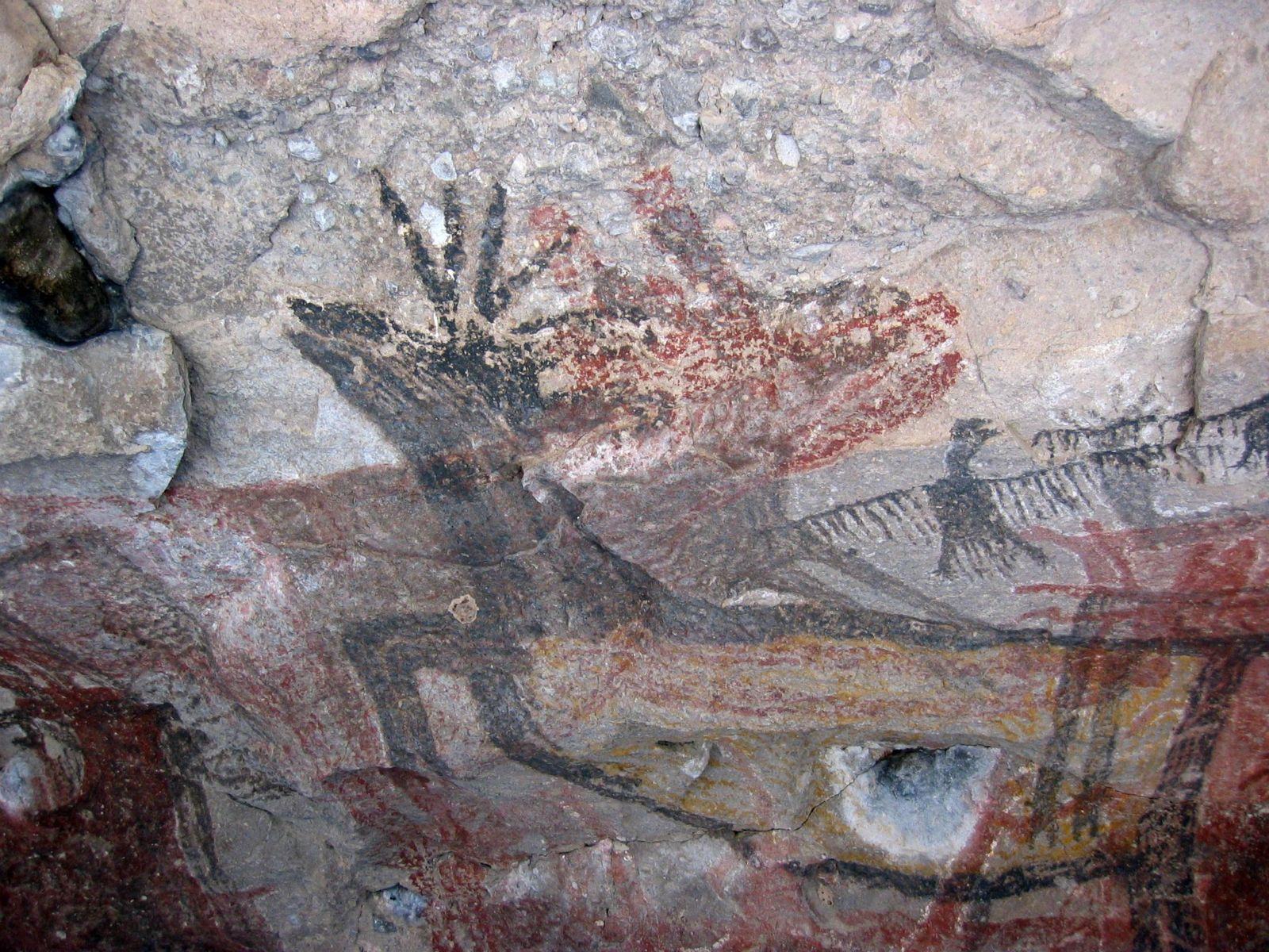 Closeup of a striking Pintada panel.  A male black deer facing left with yellow body is superimposed over a female black deer facing right.  A red figure overlays the female deer.